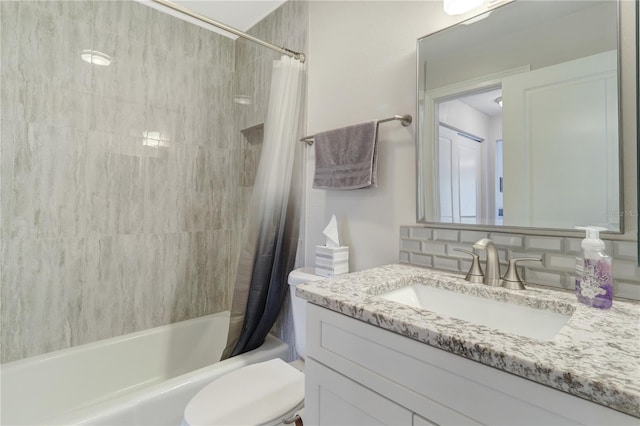 full bathroom with vanity, shower / tub combo, and toilet