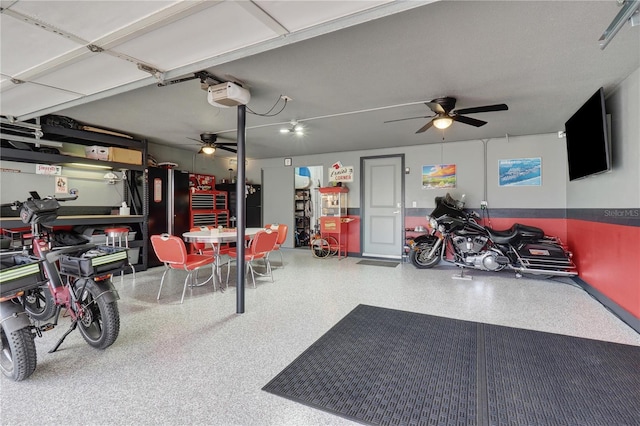 garage featuring a ceiling fan and a garage door opener