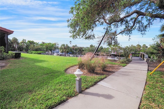 view of property's community with a lawn