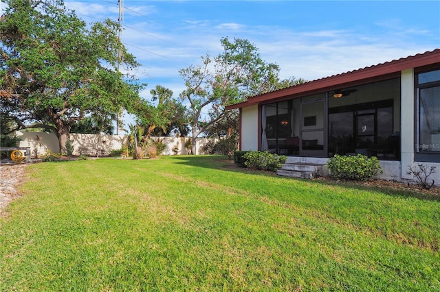 view of yard with a fenced backyard and a sunroom