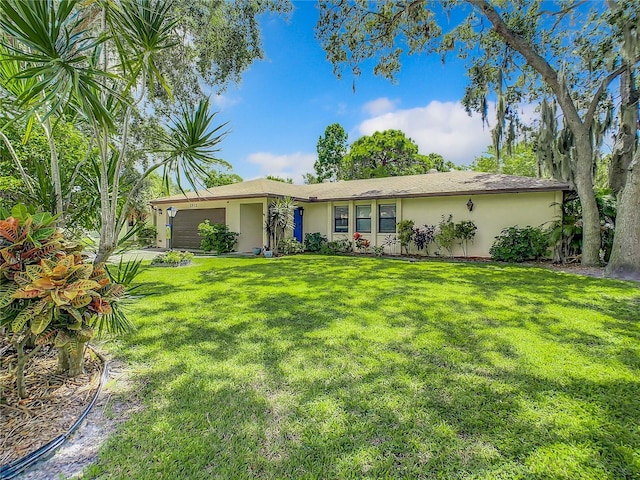 single story home featuring a front yard and a garage