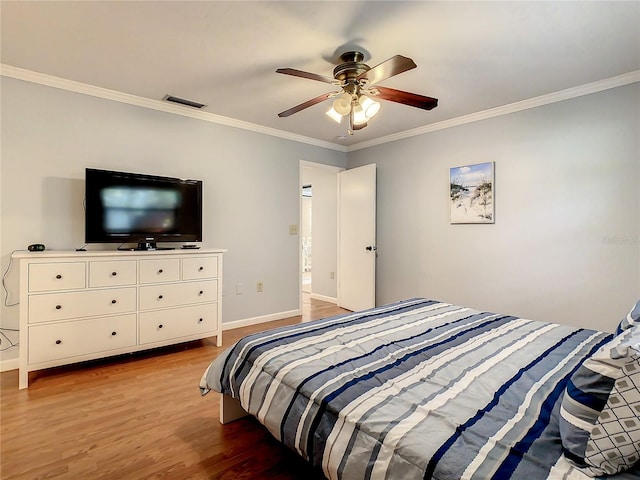 bedroom with ceiling fan, hardwood / wood-style floors, and ornamental molding