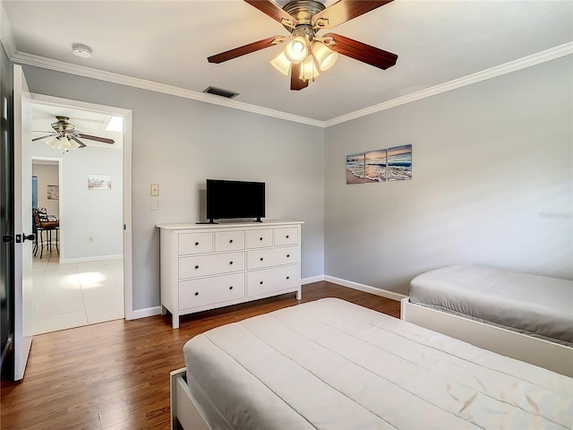 bedroom featuring dark hardwood / wood-style flooring, ceiling fan, and ornamental molding