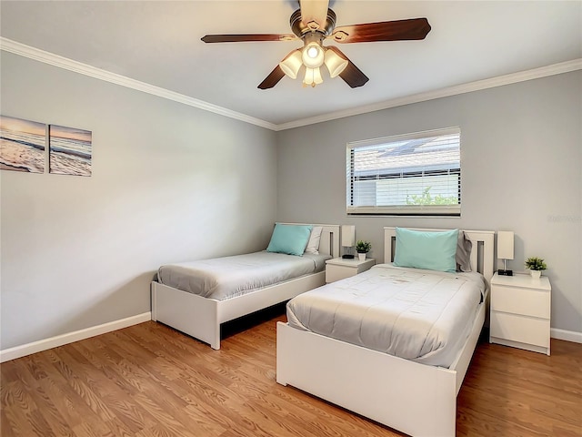 bedroom with ornamental molding, ceiling fan, and light wood-type flooring