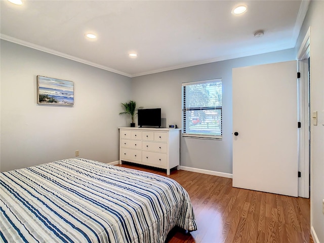 bedroom with crown molding and light wood-type flooring