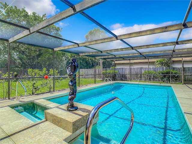 view of pool with a lanai and an in ground hot tub