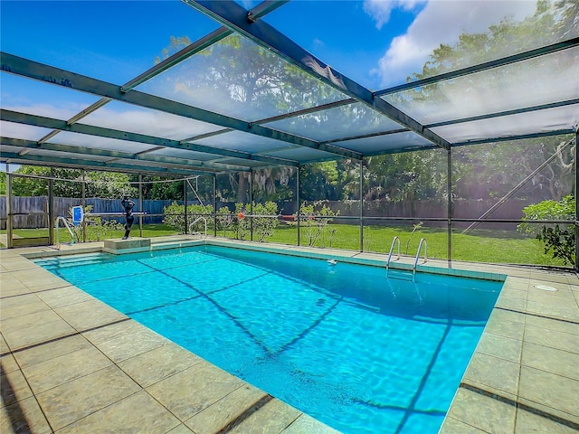 view of pool featuring a patio, a lanai, and a lawn