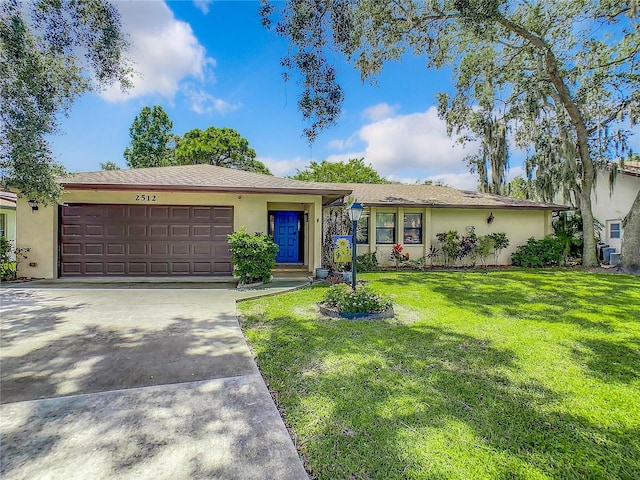 ranch-style house featuring a front yard and a garage