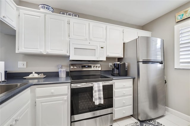 kitchen with white cabinets, light tile patterned floors, and appliances with stainless steel finishes