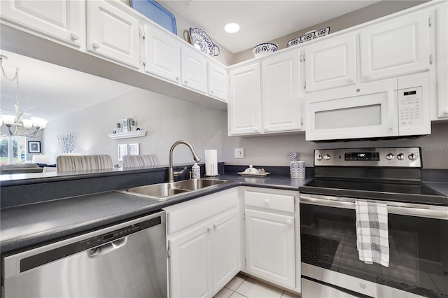 kitchen featuring appliances with stainless steel finishes, white cabinetry, and sink