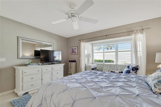 bedroom featuring ceiling fan and light carpet