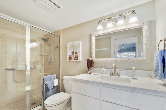 bathroom with vanity, an enclosed shower, and toilet