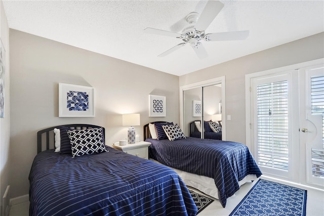 bedroom featuring carpet, a textured ceiling, a closet, and ceiling fan