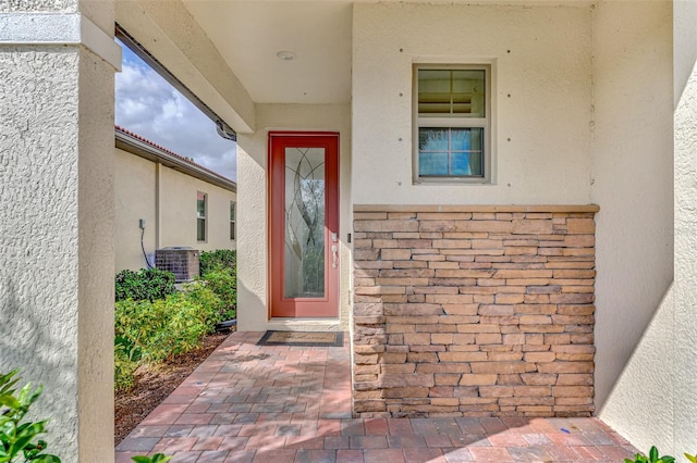 doorway to property featuring central AC unit