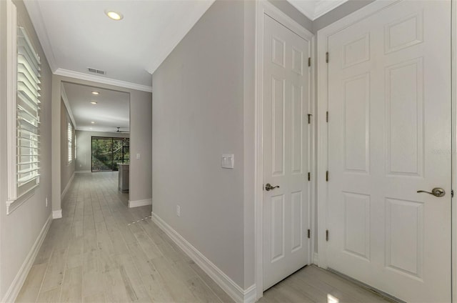 hallway featuring light hardwood / wood-style flooring and ornamental molding