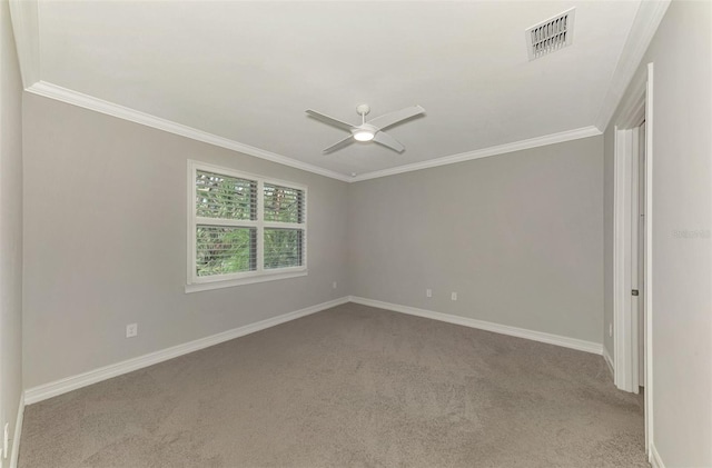 empty room featuring light carpet, ceiling fan, and crown molding