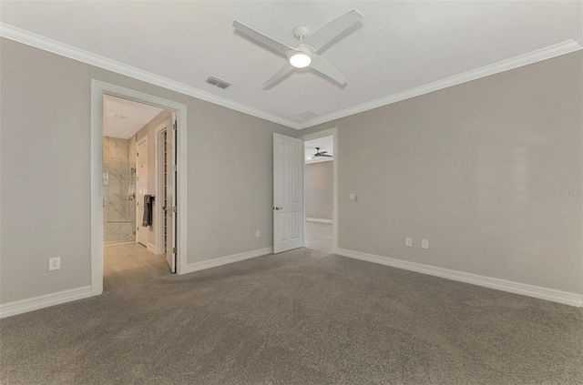 spare room featuring light colored carpet, ceiling fan, and crown molding