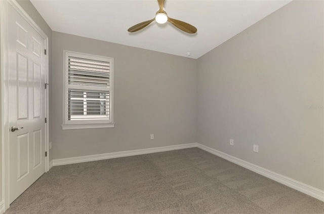 carpeted spare room featuring ceiling fan