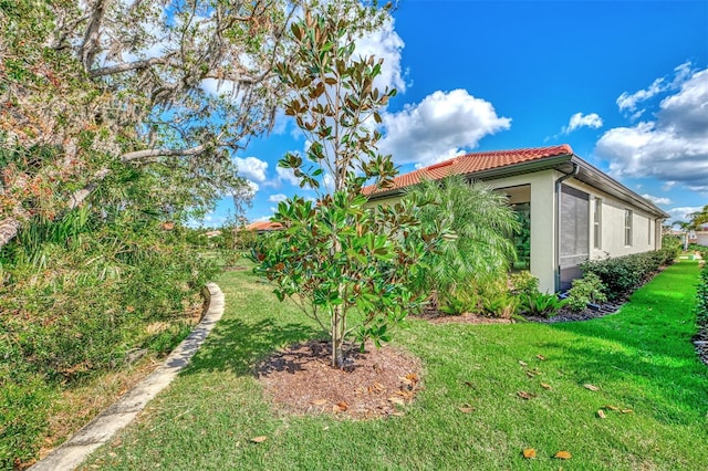 view of side of property with a lawn