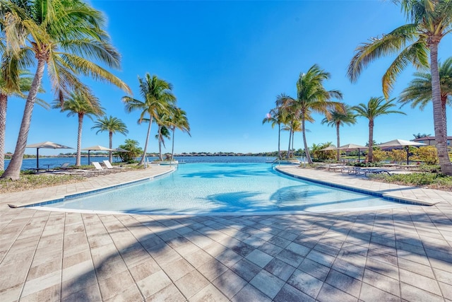 view of pool featuring a water view