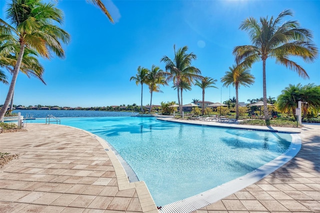 view of swimming pool with a water view