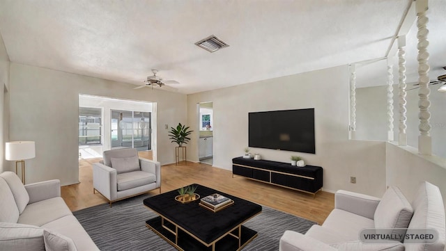 living room with ceiling fan and wood-type flooring