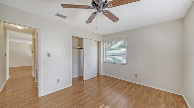 unfurnished bedroom with ceiling fan, a closet, and light hardwood / wood-style flooring