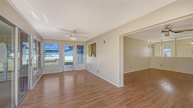 unfurnished sunroom with ceiling fan