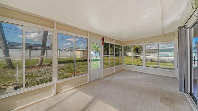 unfurnished sunroom featuring lofted ceiling