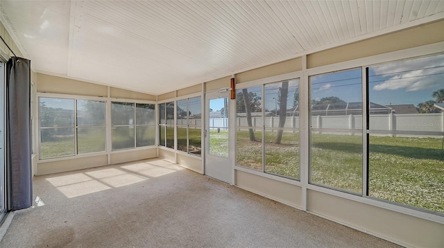 unfurnished sunroom featuring lofted ceiling