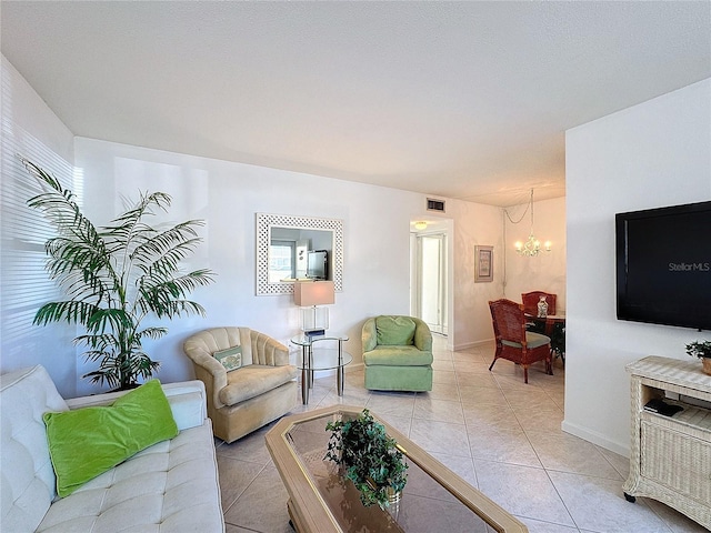 tiled living room with an inviting chandelier