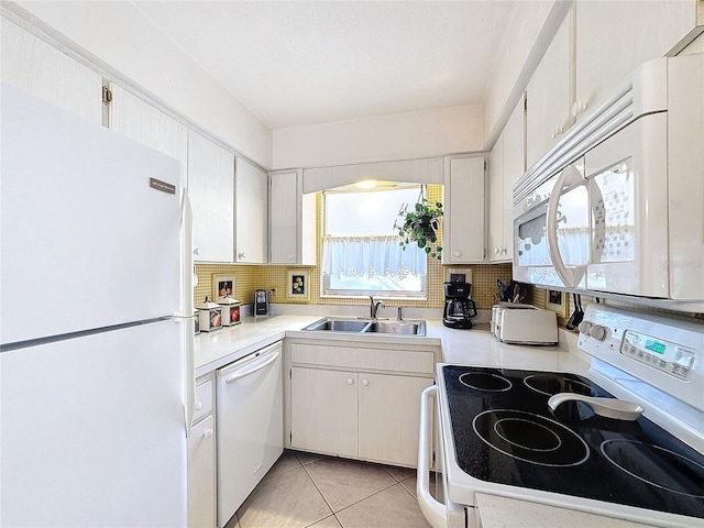 210 Park Blvd N Unit 129, Venice, FL 34285 - kitchen featuring white appliances, a sink, tasteful backsplash, and light countertops