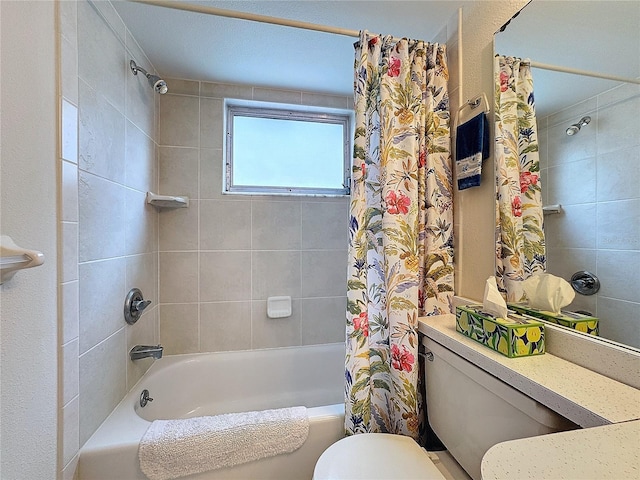 bathroom featuring shower / tub combo and toilet