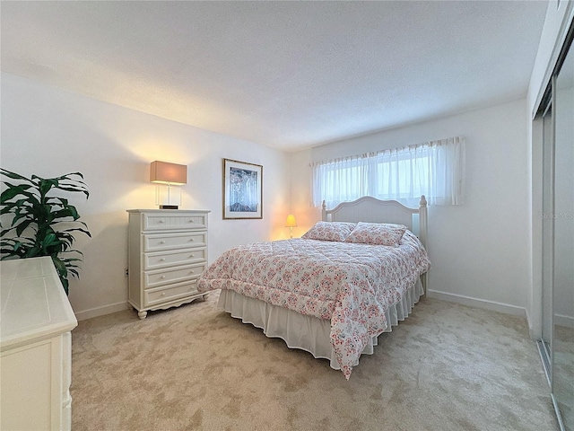 carpeted bedroom with a closet