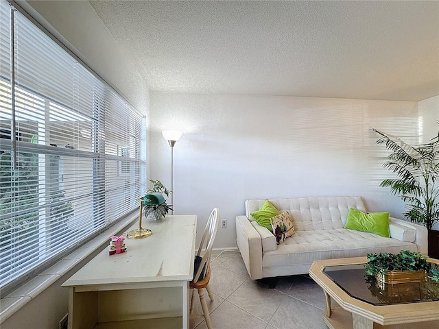 living room featuring light tile patterned flooring and a textured ceiling