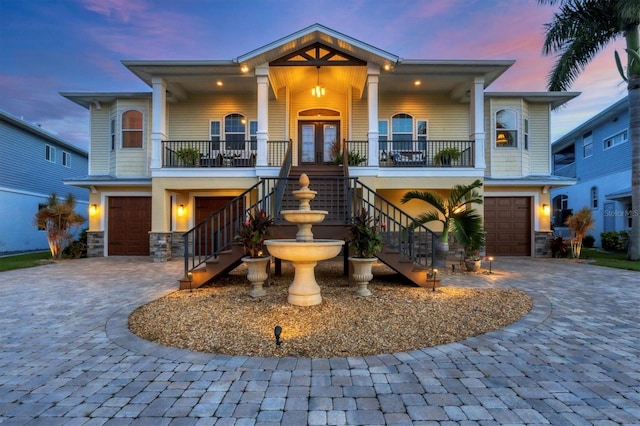 view of front of property with a porch and a garage