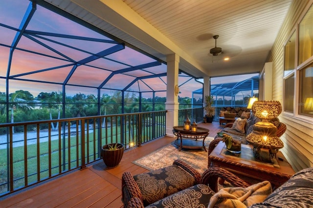 sunroom featuring ceiling fan and a pool