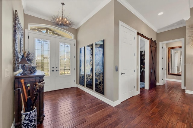 entryway with crown molding, french doors, dark wood-type flooring, and an inviting chandelier