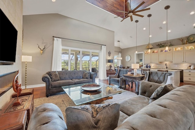 living room with ceiling fan, sink, high vaulted ceiling, and light hardwood / wood-style floors