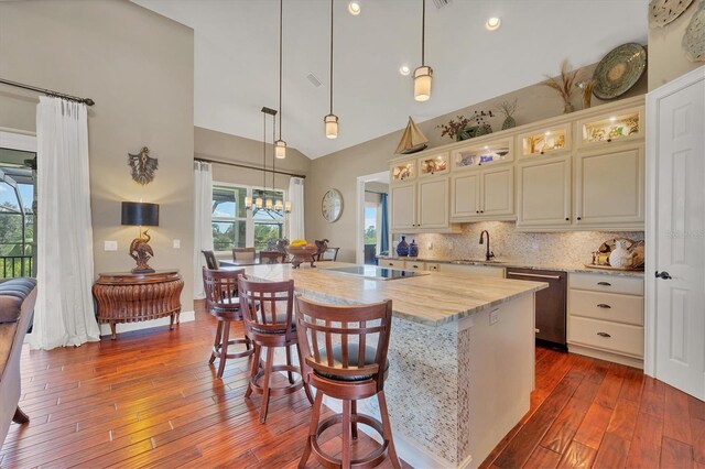 kitchen with dishwasher, hardwood / wood-style floors, a center island, and plenty of natural light