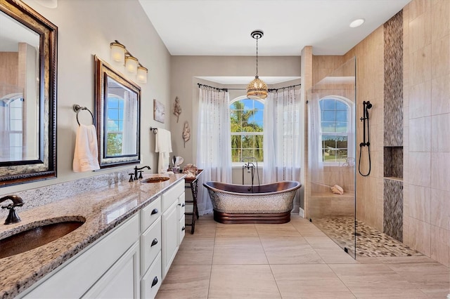 bathroom with a chandelier, tile patterned flooring, vanity, and independent shower and bath