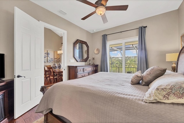 bedroom with access to outside, ceiling fan, and wood-type flooring