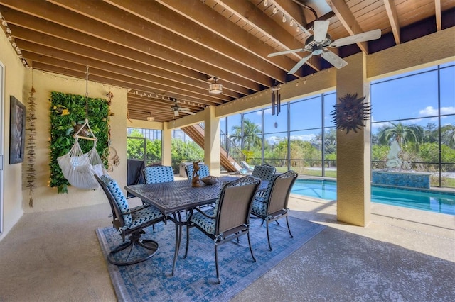 view of patio with glass enclosure and ceiling fan