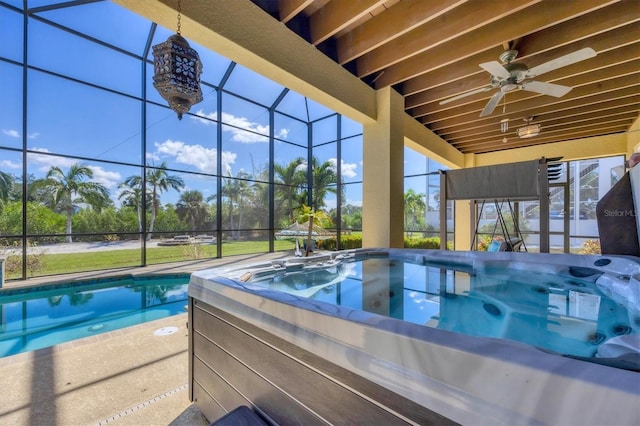 view of swimming pool featuring a hot tub, ceiling fan, and a lanai