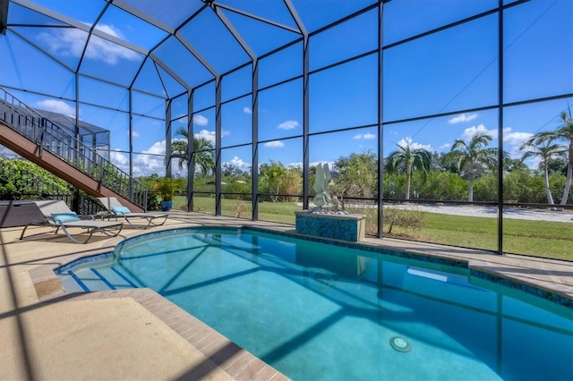 view of pool featuring glass enclosure and a patio area