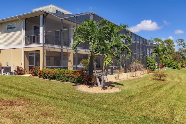 exterior space featuring a lawn, glass enclosure, cooling unit, and a pool