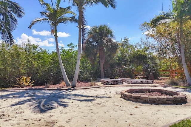 view of yard with an outdoor fire pit