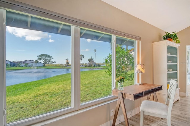 doorway to outside featuring hardwood / wood-style floors, a healthy amount of sunlight, and a water view