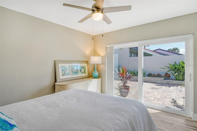 bedroom with light wood-type flooring, access to outside, and ceiling fan