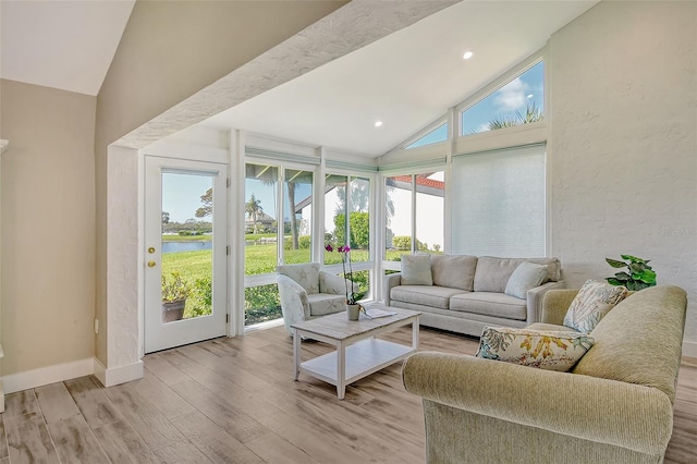 sunroom featuring lofted ceiling